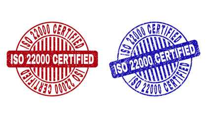 Grunge ISO 22000 CERTIFIED round watermarks isolated on a white background. Round seals with grunge texture in red and blue colors.