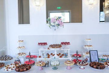 Delicious luxury candy bar with macaroons, cake pops, cupcakes and other sweets