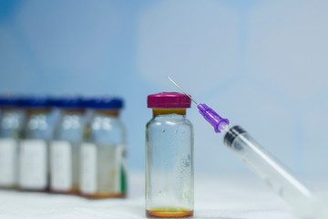 Close up vaccine vial needle dose flu vaccine drug syringe medical concept subcutaneous injection...