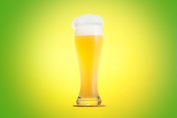 Golden beer in glass with foam, alcohol beverage,  bubbles.