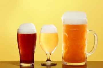 Golden beer in glass with foam, alcohol beverage,  lager cold.