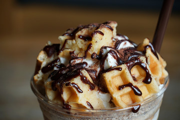 Waffles with chocolate sauce and whipped cream.