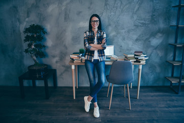 Full length body size view of nice attractive lovely slim thin fit cheerful brunette lady in checked shirt jeans denim trend at industrial loft style interior work place station indoors
