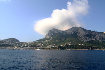 The majical Italian Island of Capri in the Bay of Naples. Cloud hangs over the highest point of the island.