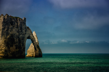Etretat is best known for its white chalk cliffs, including natural arches. Normandy, France, Europe