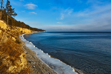 Fototapeta na wymiar Coastline of Baikal lake in December with blue sky