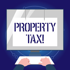 Writing note showing Property Tax. Business concept for bills levied directly on your property by government Hands on Keyboard Front White Monitor with Screen Protector