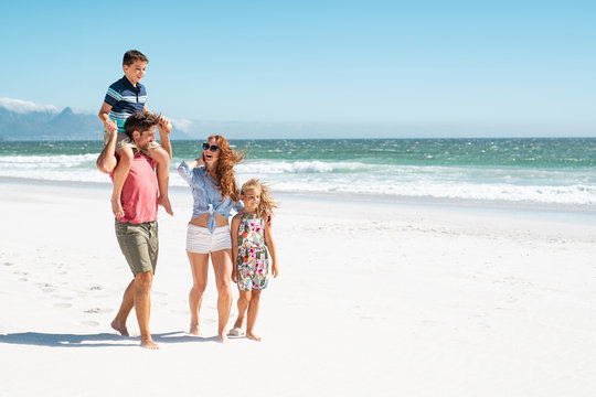 Family Walking At Beach