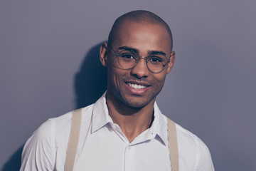Close up photo beautiful amazing dark skin he him his macho toothy stunning manager employer collar financier boss chief shaved face wear specs pastel suspenders white shirt isolated grey background