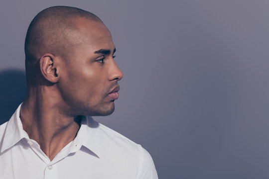 Close up side profile photo amazing dark skin he him his macho perfect head hairdo condition look empty space not smiling wondered listen news wear white shirt isolated grey background