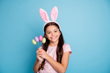Obraz na płótnie Canvas Closeup photo portrait of lovely with beaming teeth smile white caucasian girl in pink tender gentle t-shirt holding collection on handmade craft diy easter eggs in hands isolated vibrant background 