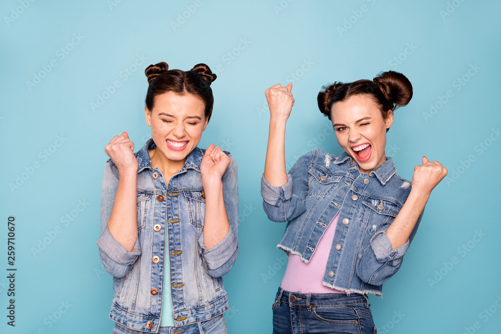 Sticker Portrait of delighted crazy satisfied hipsters winning lottery competition having luck raising fists closing eyes yelling yeah wearing blue casual spring clothing isolated on pastel background 