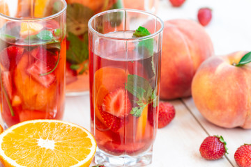 Berries Mojito with Energy Drink, Strawberry, Peach and Sweet Syrup. fresh mohitos cocktail on white background. Mojitos with mint Strawberry, orange. high key photo. Healthy berry fruit cocktail.