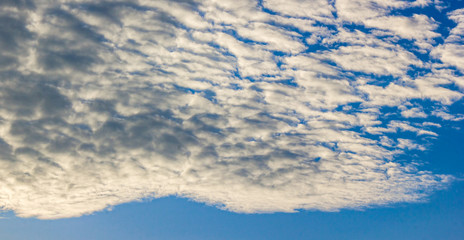 Tropical cloudy on blue sky by evening sun light.