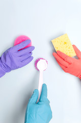 Vertical shot.Concept of cleaning compony and cleaning team.Workers holding variois of cleaning supplies for washing and removing dust