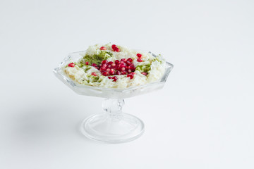 Traditional Turkish,Ramadan milky light dessert Gullac in the stylish glass bowl on white wwith copy space.
