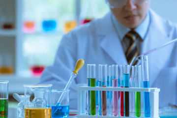Male scientist collecting experimental samples.