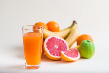 Fresh orange juice with fruits, isolated on white