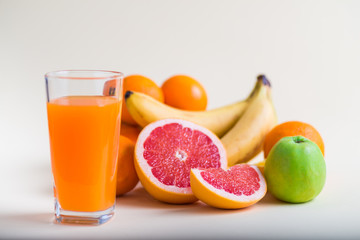 Fresh orange juice with fruits, isolated on white