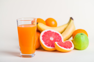 Fresh orange juice with fruits, isolated on white