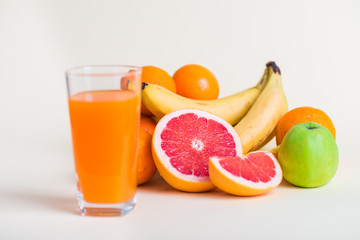 Fresh orange juice with fruits, isolated on white