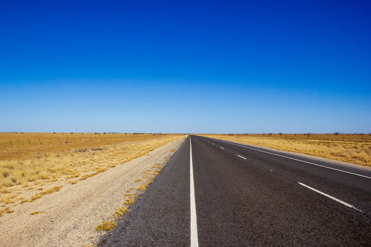 traight road in the dessert of Australia on the Flinders Hightway, Quennsland Australia