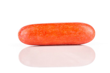 One whole red sweet licorice comfit isolated on white background