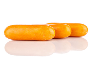 Group of three whole orange sweet licorice comfit isolated on white background