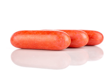 Group of three whole red sweet licorice comfit isolated on white background