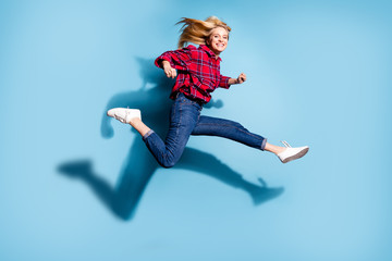 Fototapeta na wymiar Full length body size view portrait of nice charming attractive cheerful cheery crazy girl wearing checked shirt running fast isolated on teal turquoise bright vivid shine background