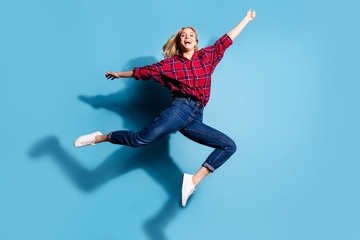 Fototapeta na wymiar Full length body size view portrait of nice attractive cheerful cheery girl wearing checked shirt holding invisible thing having fun isolated on turquoise bright vivid shine background