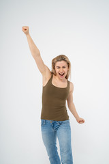 Young attractive girl is very happy and raises her hand up. Isolated on white background