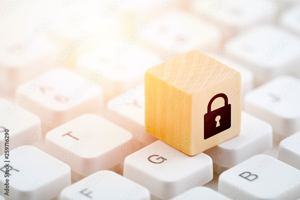 Poster wooden block with lock graphic on computer keyboard. computer security concept.