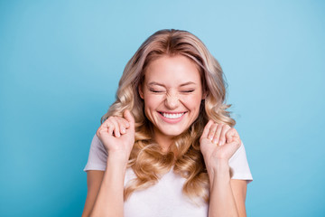 Close up photo beautiful yelling amazing her she lady satisfied lucky facial expression hands arms palms fists raised eyes closed wearing casual white t-shirt clothes outfit isolated blue background