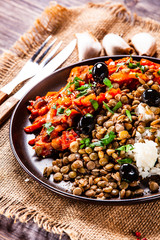 Rice with lentils and vegetables on wooden table