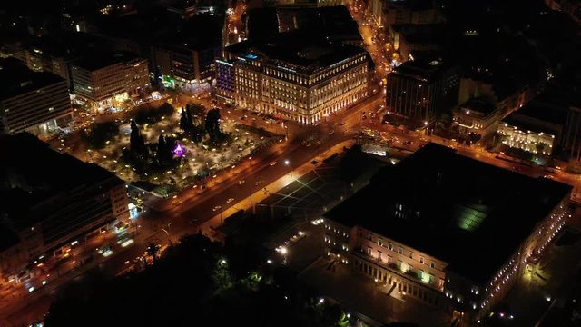 Aerial drone night video from famous illuminated Syntagma square and Greek Parliament  building, Athens historic centre, Attica, Greece