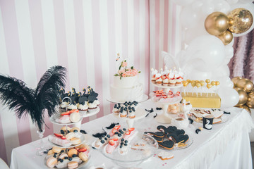 White swan Candy Bar. Delicious sweet buffet with tiered cake. A beautiful buttercream layer cake decorated with white swan cake topper.