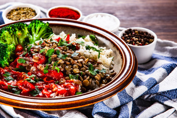 Rice with lentils and vegetables on wooden table