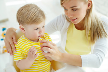 Mom baby brushing teeth