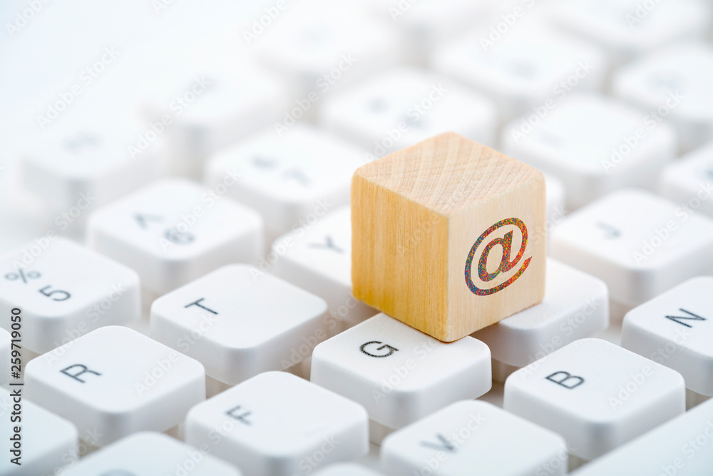 Poster wooden block with colorful internet symbol on computer keyboard