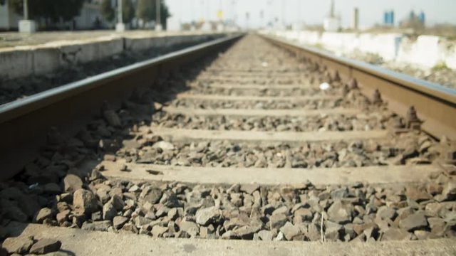 Detail of train tracks leading to station. dolly in . Shot on Red Raven