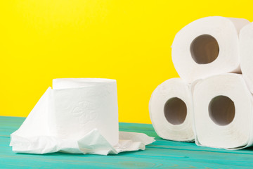 Toilet paper stacks  on bright yellow background
