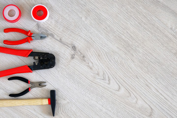 Flat lay of tools, parts, hammer and pliers on white wooden background, close up. Repair in home or apartment with special tools. Copy space.