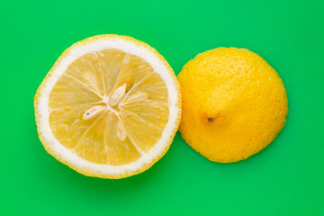 sliced lemon on green background 