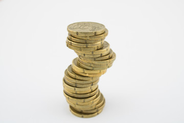 Fototapeta na wymiar Unstable economy. Stack twenty euro cent coins on white background. Savings.