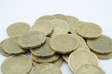 Several twenty euro cent coins on white background. Coins with little value.