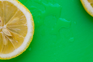 sliced lemon on green background 