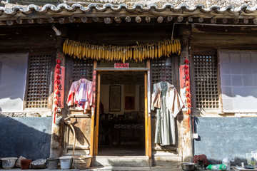 Mar 2014, Chuandixia, Hebei, China: corn, clothes and red pepper hanged out to dry at the entrance...