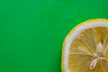 sliced lemon on green background 