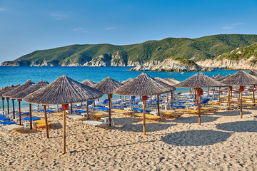 Beach with loungers and umbrellas in Greece